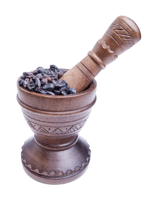 Wooden mortar with dry barberry